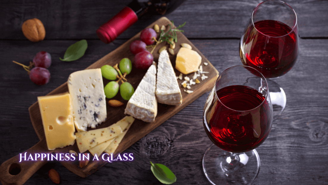 2 glasses of red wine next to a board with cheese and grapes