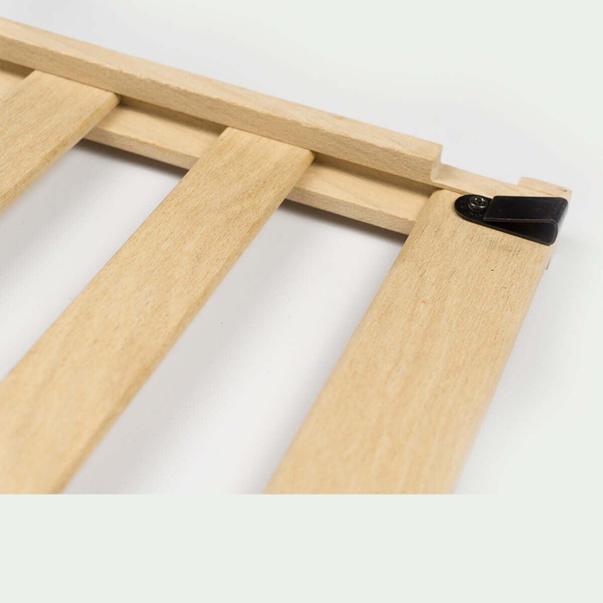 Close-up of wooden slats with a black connector detail for furniture assembly.