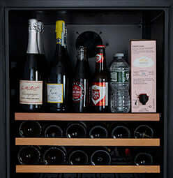 Smith & Hanks 166 Bottle Dual Zone Premium Stainless Steel Wine Refrigerator image of wine bottles on wine shelf